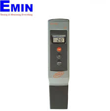 Technician checking a pH meter and probe during instrument inspection